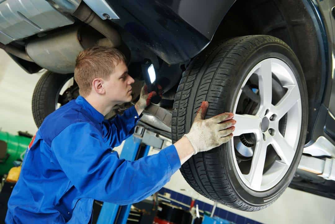 Mechanic Doing Wheel Alignment Mechanic Doing Wheel Alignment