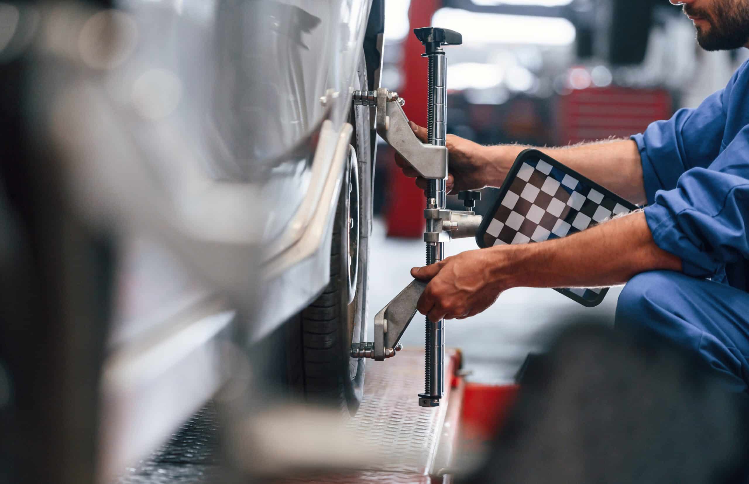Sitting Checking The Tire Auto Mechanic Working 2023 11 27 05 36 40 Utc Scaled No.1 Best Wheel Alignment In Irving Tx- Express Auto Irving