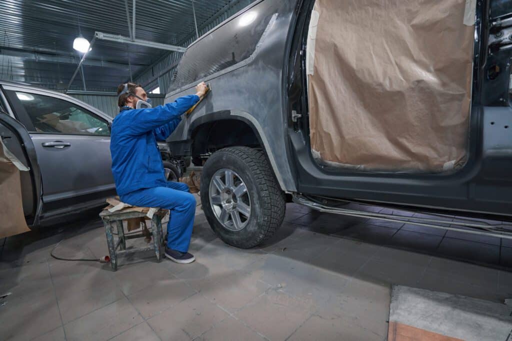 Car Painter In Respirator Hard Working In Garage 2023 11 27 05 36 57 Utc No.1 Best Auto Body Repair In Irving Tx- Express Auto